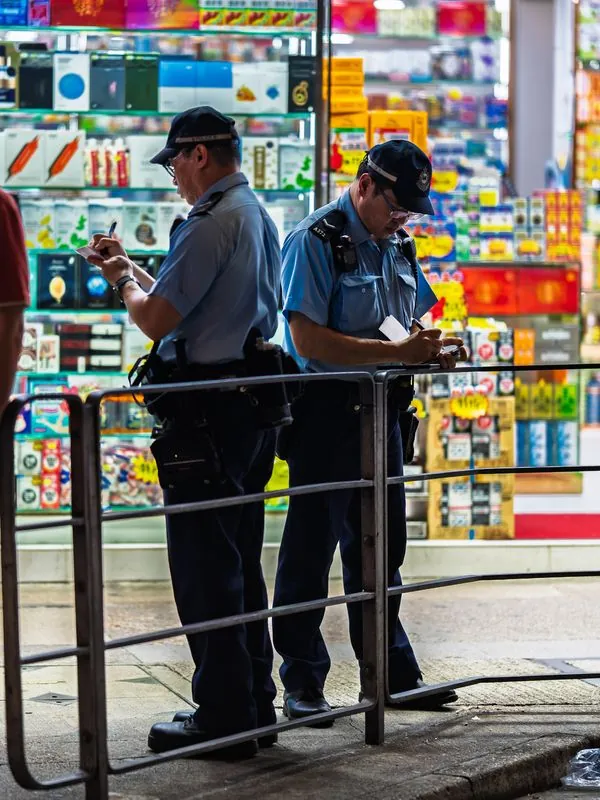 these hong kong policemen are scribbling two completely different sets of notes (i think)