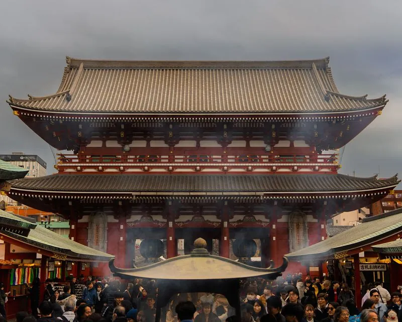 the incense burner smokes through the gate and the crowd waits